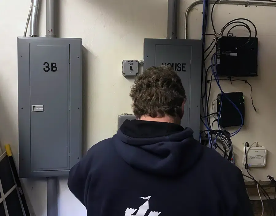 Castle Electric technician servicing apartment and house electrical panels in Eastern Massachusetts