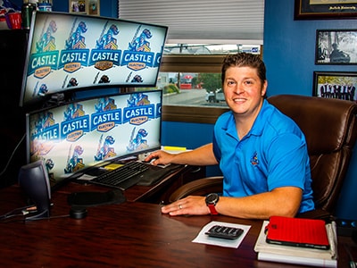 Castle Electric owner working at desk