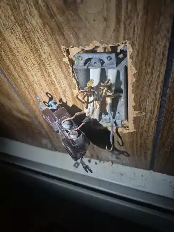 open outlet with exposed wiring