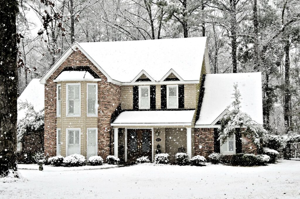 Winter snow falling on an executive home in Newton, MA